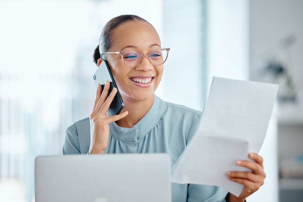 Happy business woman talking on a phone call, discussing contract with a client or colleague. Femal